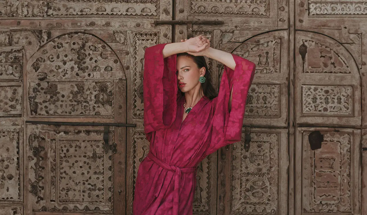 a woman in a pink robe posing for a picture